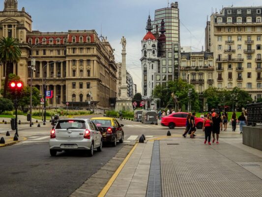 Vibrant cityscape of Buenos Aires featuring historic architecture and daily urban life on a busy street.