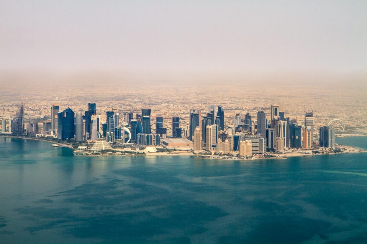 Stunning aerial view of the Doha skyline under a clear sky, showcasing modern architecture in Qatar.
